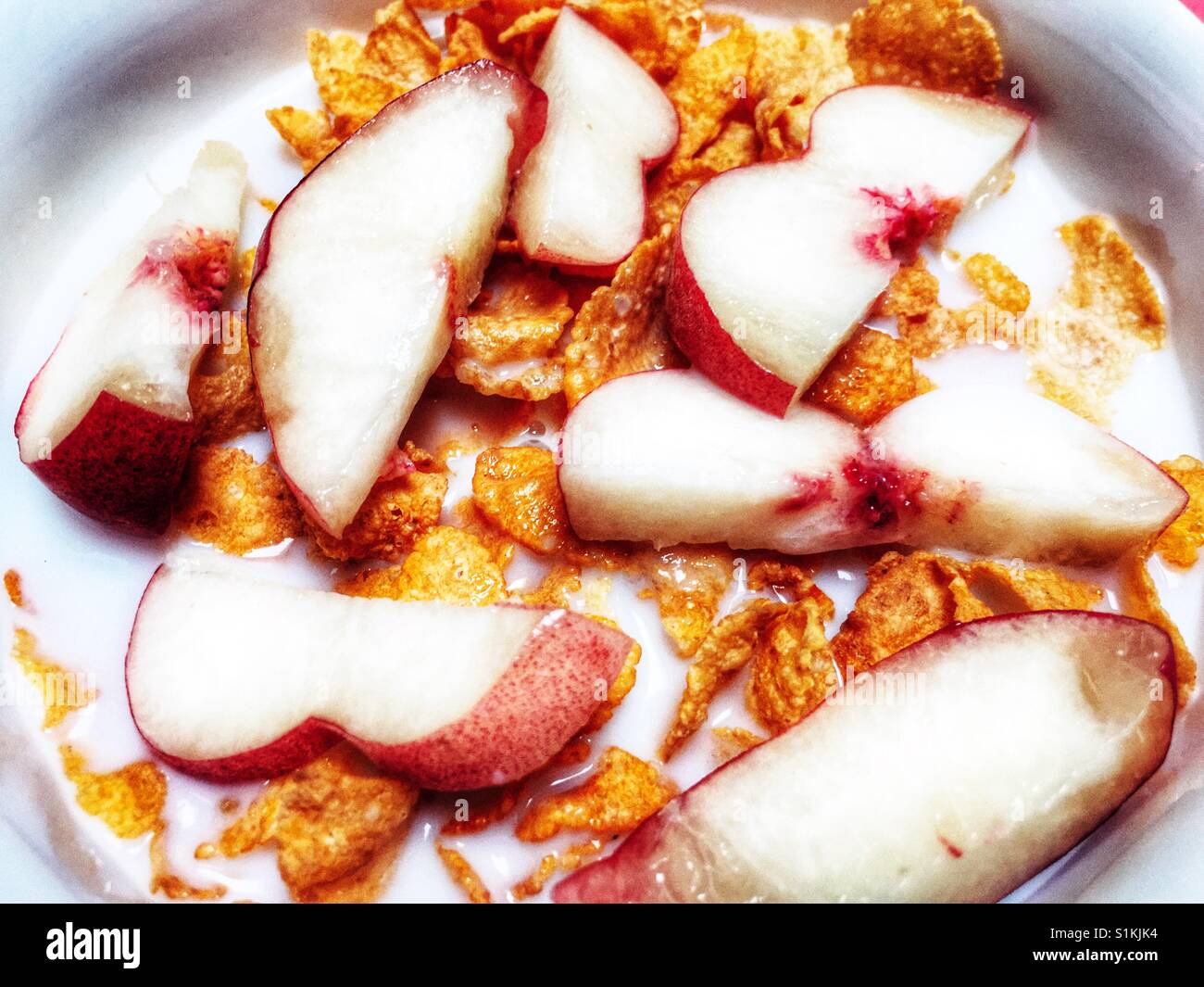 Cornflakes mit in Scheiben geschnittenen Pfirsiche - Smartphone-aufgenommenes Stockfoto