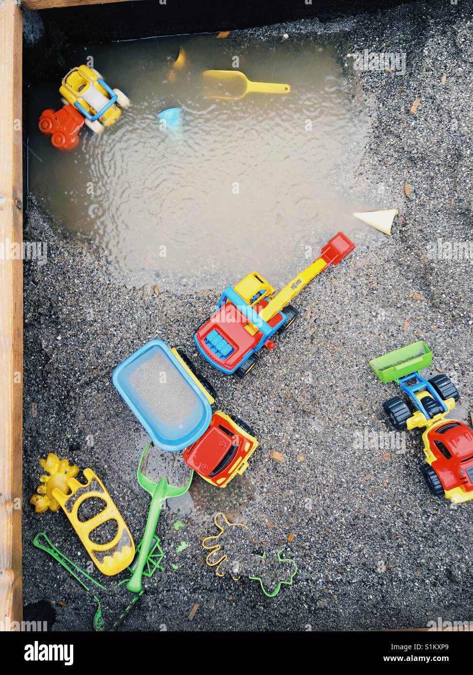 Lonely Spielzeug in den Sand, während eines Niederschlages - Smartphone-aufgenommenes Stockfoto