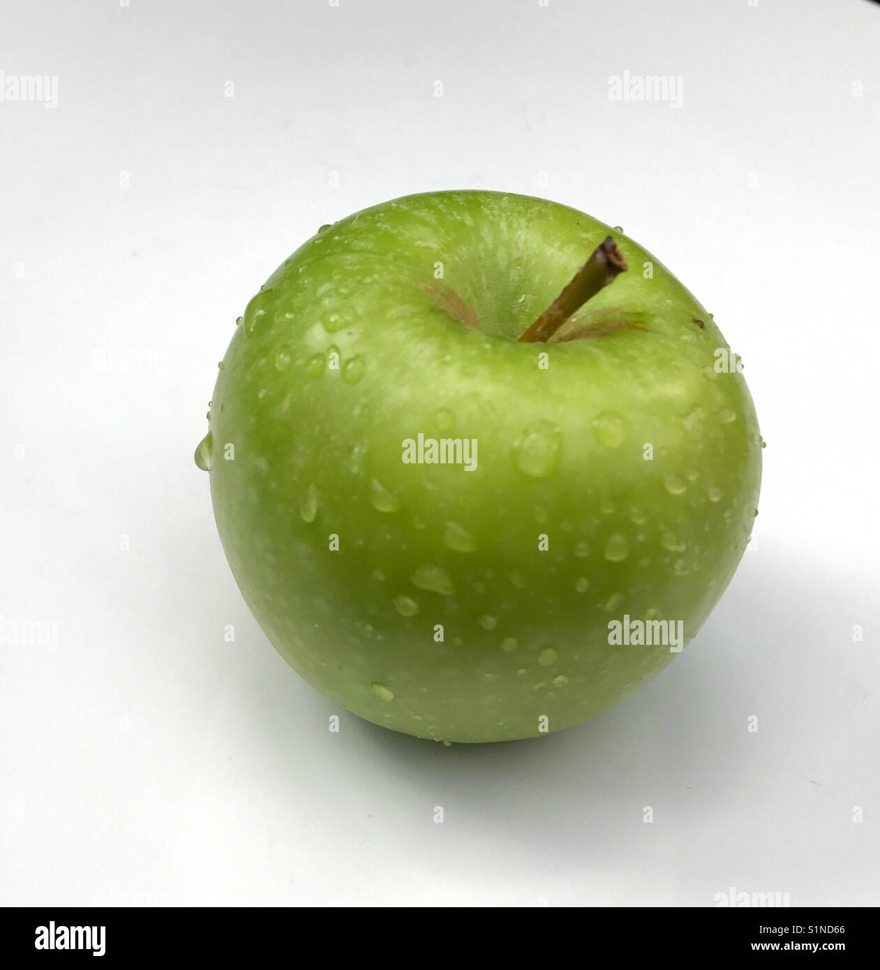 Apfel mit Wassertropfen auf weißem Hintergrund Stockfoto