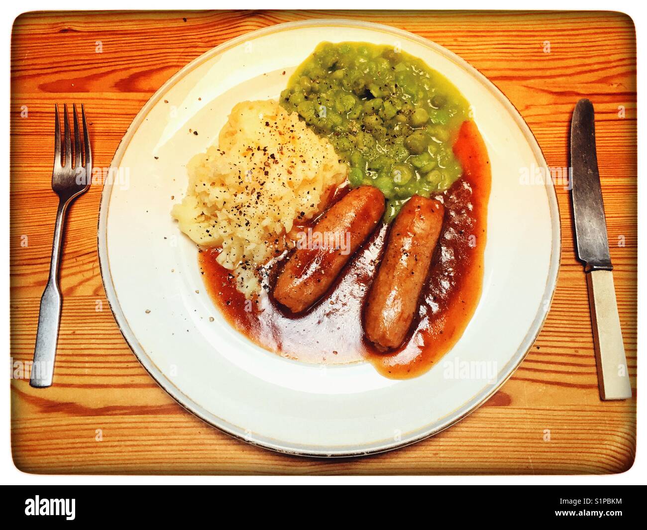 Wurst Kartoffelpüree und Erbsenpüree mit Zwiebel Sauce - Smartphone-aufgenommenes Stockfoto