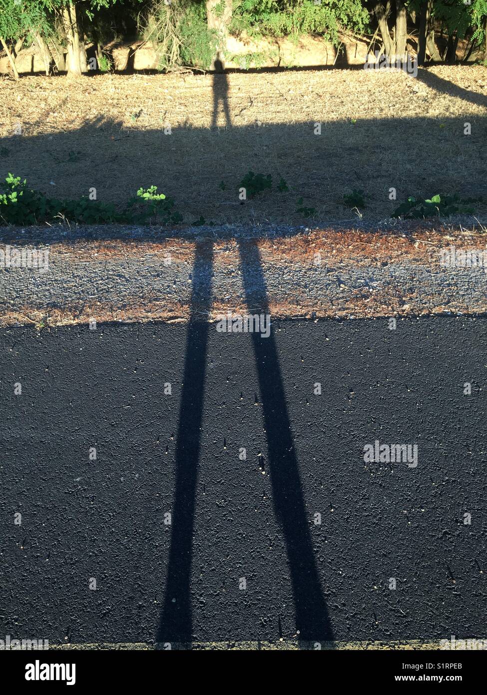 Lange Beine Schatten Stockfoto