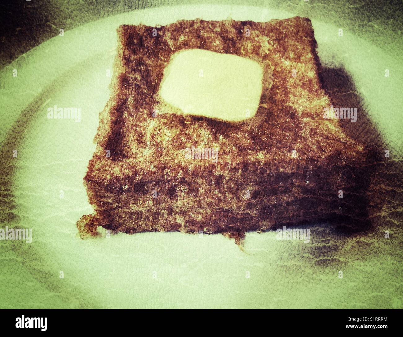 Ein fettes Stück gebuttertem Toast Stockfoto