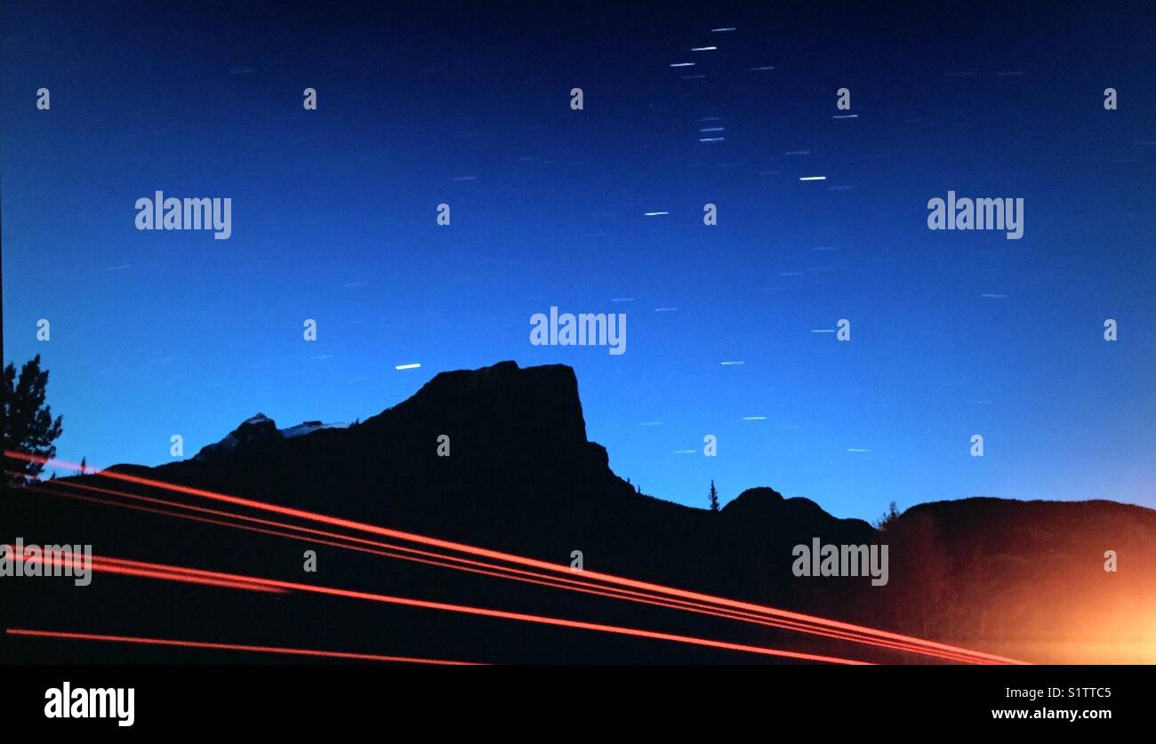 Berg Silhouette, star Trails und Rückleuchten - Smartphone-aufgenommenes Stockfoto