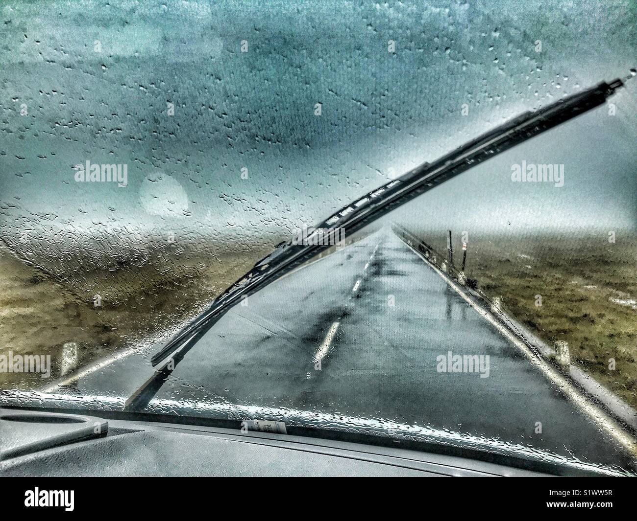 Fahrt durch Regen und Nebel auf der geraden Straße über die Hochgelegenen Hochebene von Paul da Serra, Madeira, Portugal. - Smartphone-aufgenommenes Stockfoto