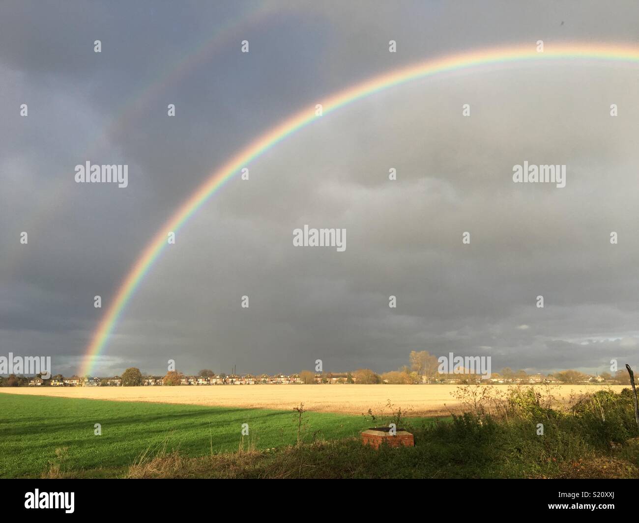 Regenbogen über Feld Stockfoto
