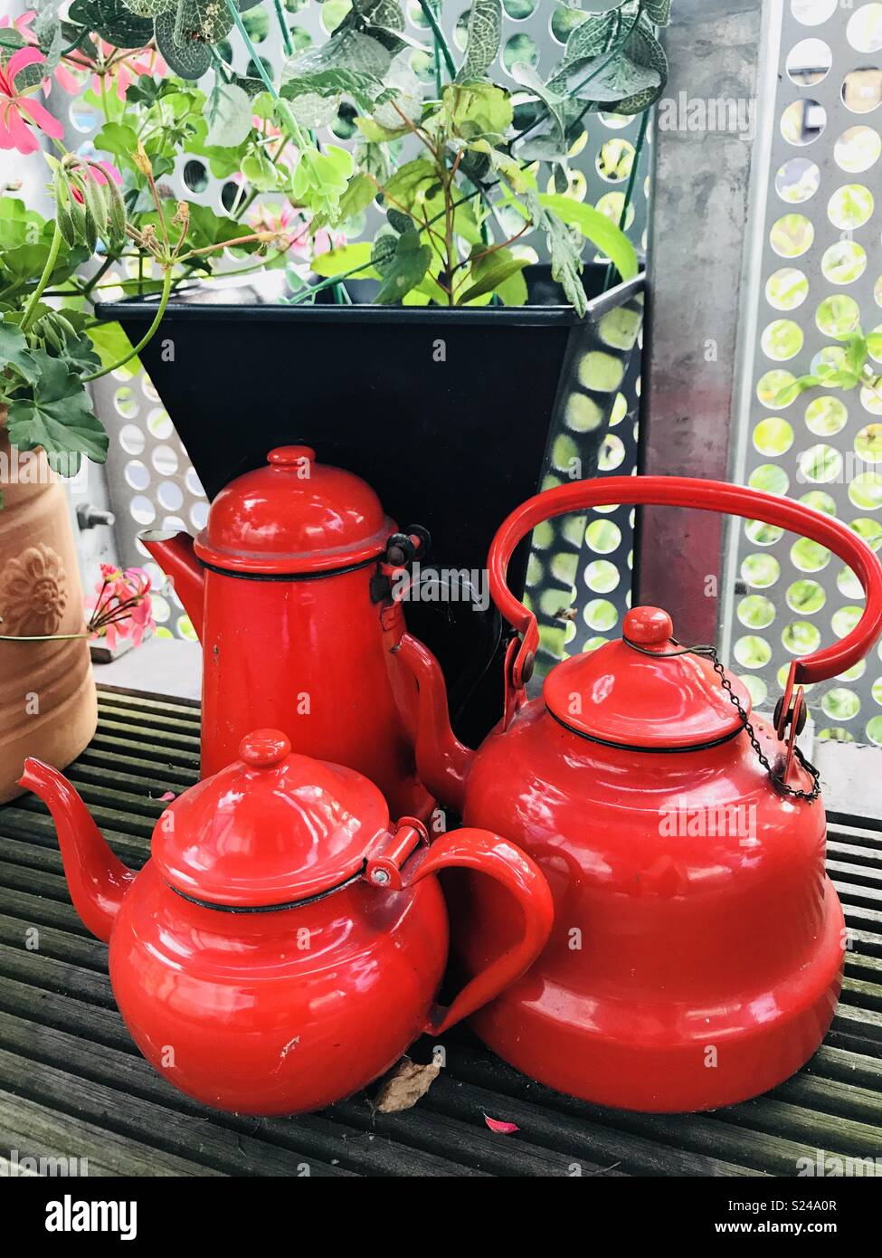 Satz von drei roter Tee Töpfe auf Balkon Terrasse Stockfoto