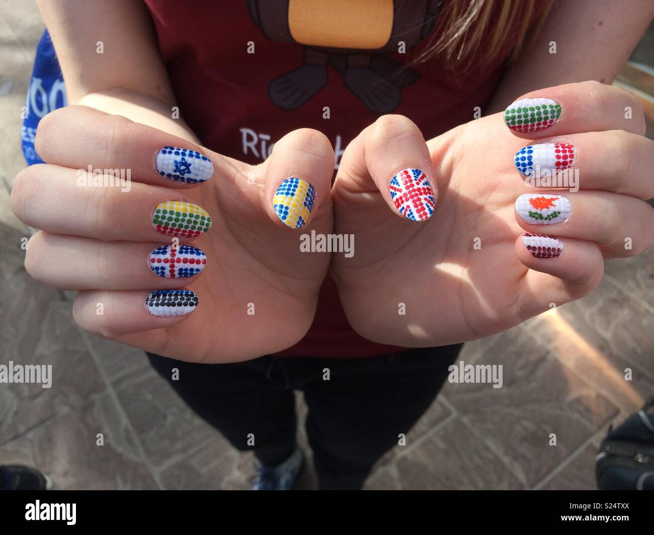 Ein Mädchen zeigt ihre Eurovision Nägel mit verschiedenen Flaggen Stockfoto