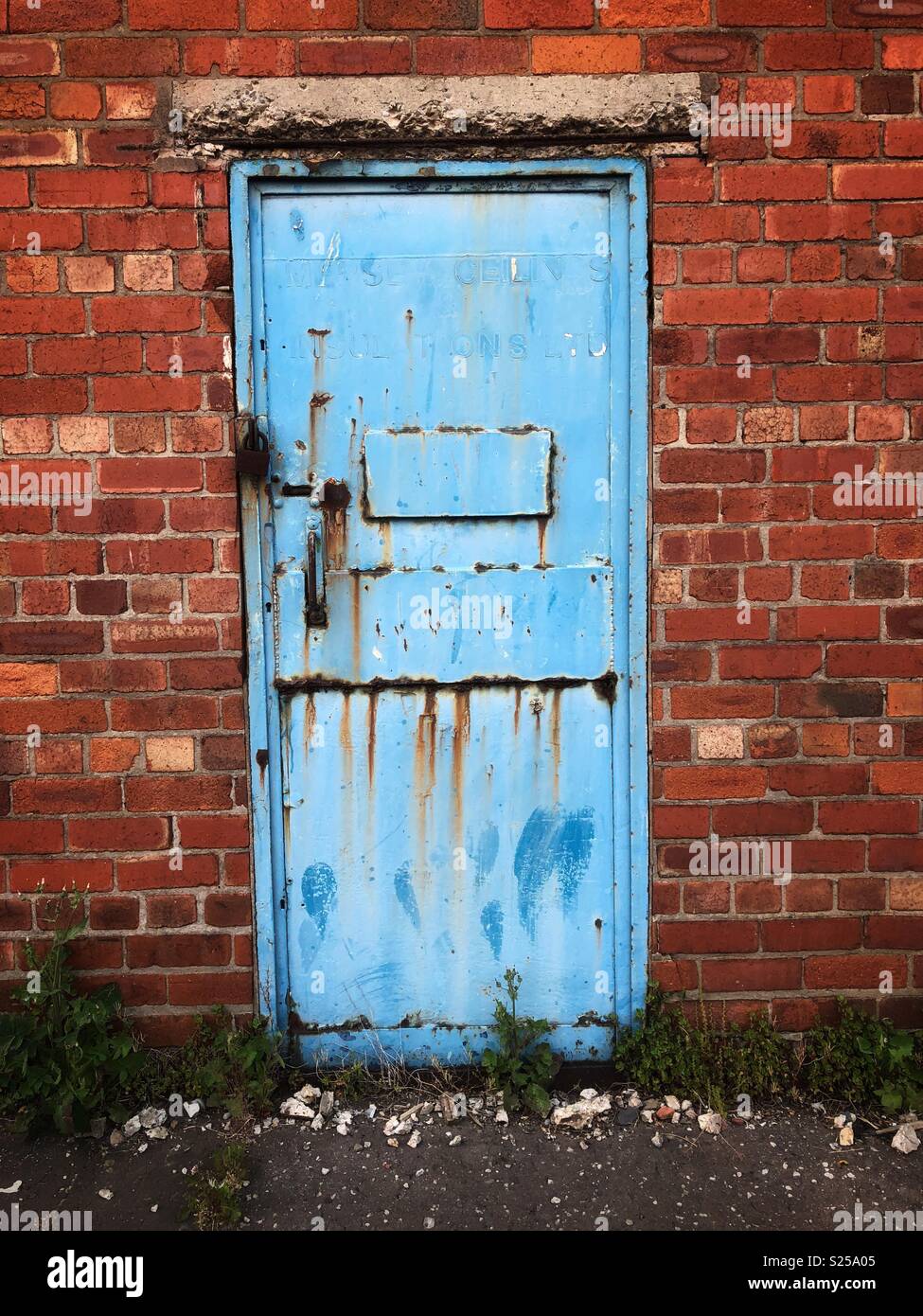 Ein blauer, rostiges Metall Tür ein verfallenes Gebäude Stockfoto