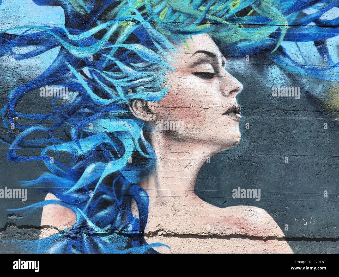 Blaue Haare Mädchen Konzept mit einem murales Design Stockfoto