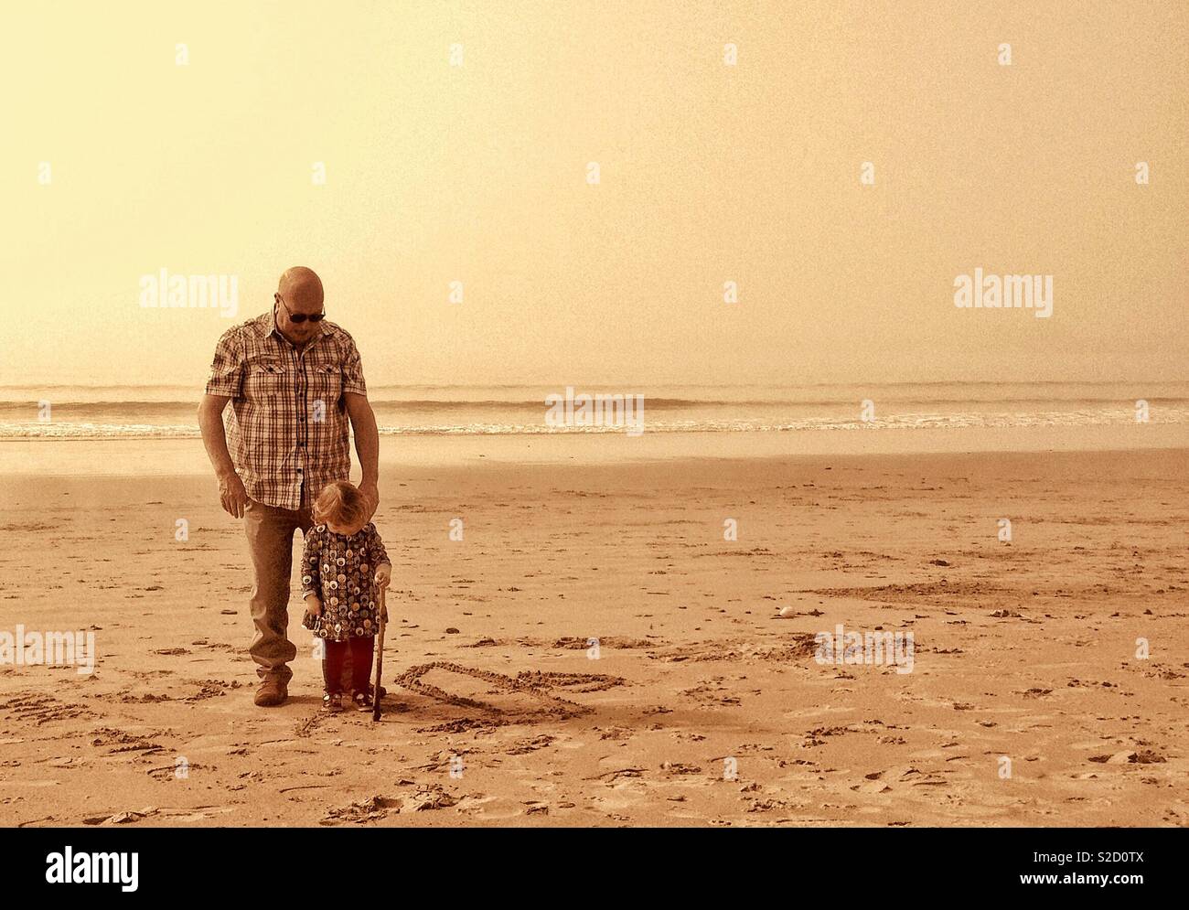 Opa und Enkelin am Strand Stockfoto