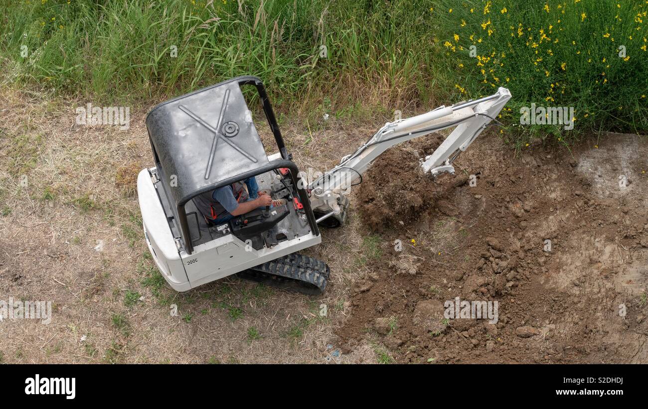 Bobcat Bagger bei der Arbeit auf einer Baustelle Stockfoto