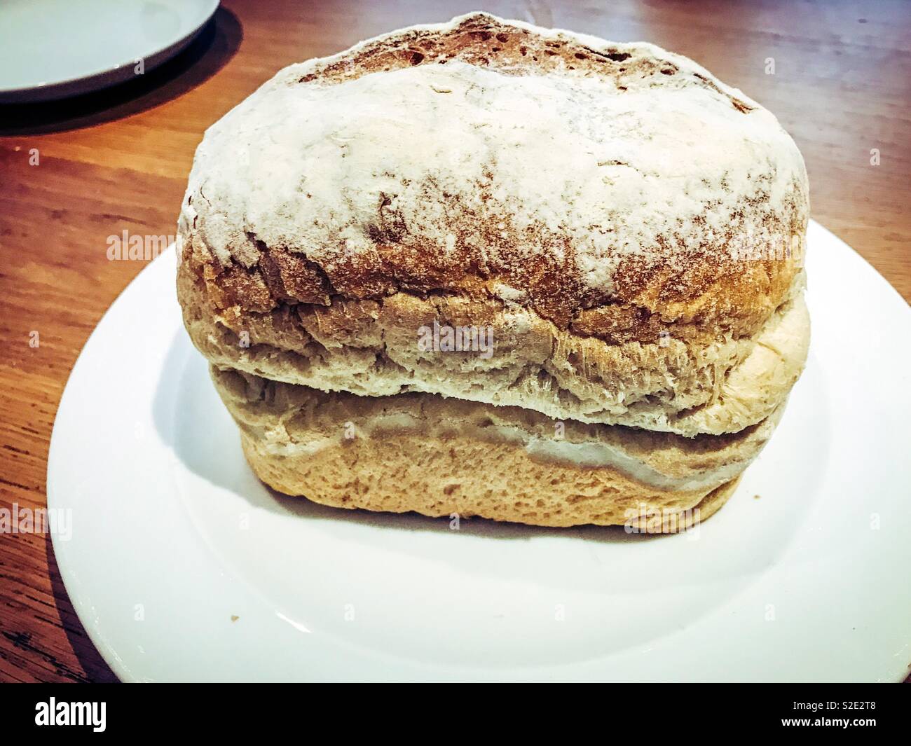 Volle Laib Weißbrot auf einer weißen Platte Stockfoto