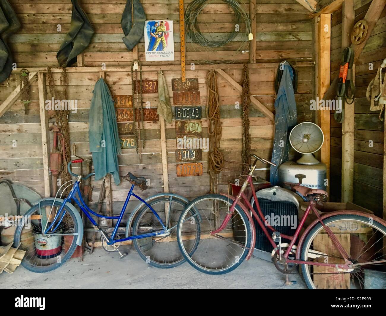 Alte garage mit alten Fahrrädern und Anzahl Platten - Smartphone-aufgenommenes Stockfoto