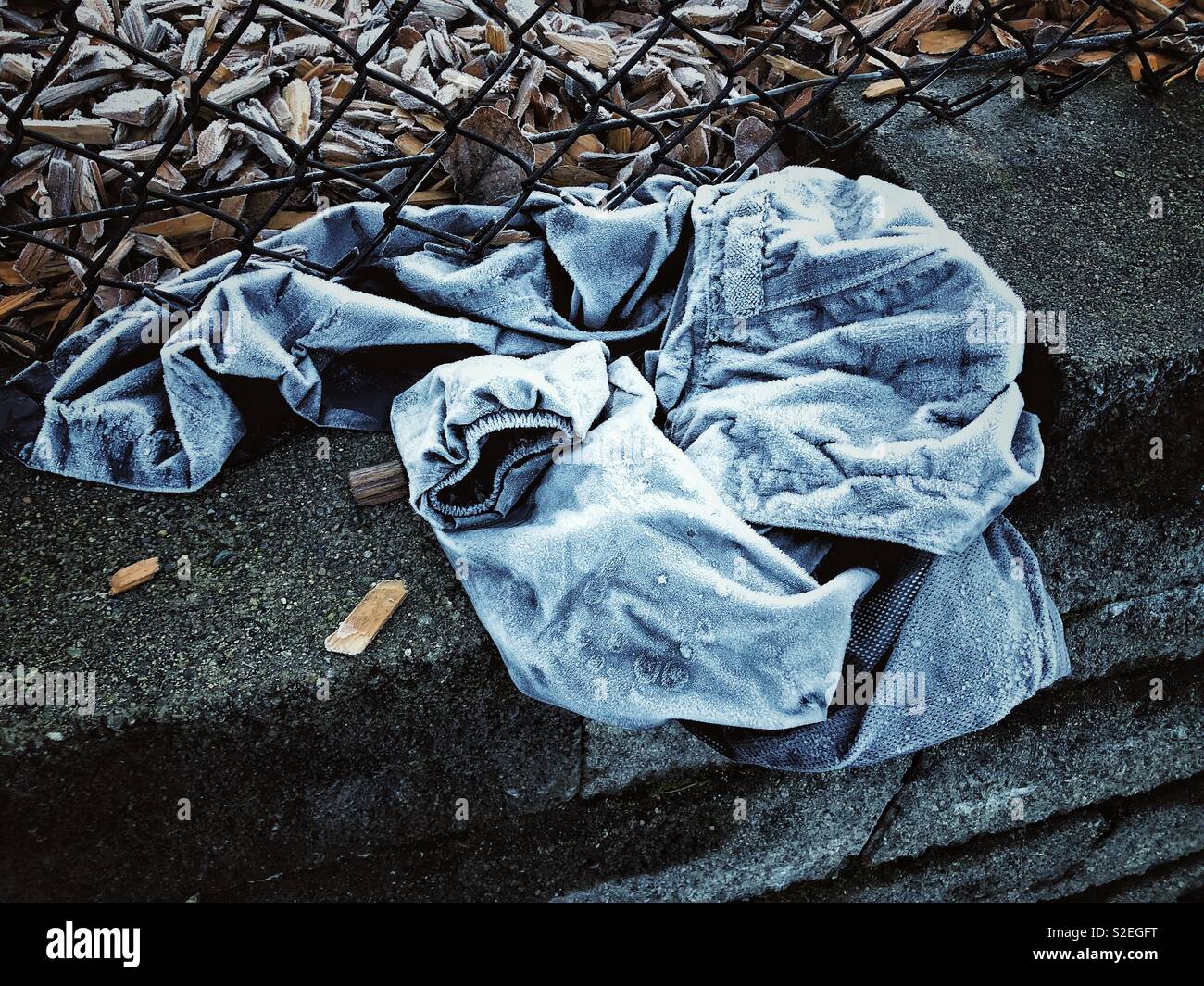 Vergessene Jacke auf dem Bürgersteig eingefroren Stockfoto