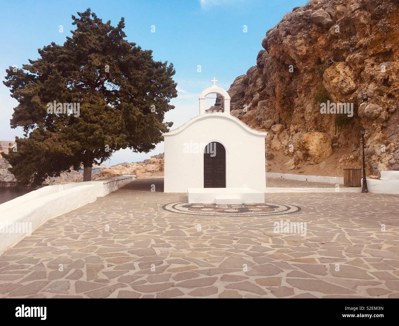 Eine kleine Griechisch-orthodoxe Kirche oberhalb St. Paul's Bay in Lindos, Rhodos, Griechenland. - Smartphone-aufgenommenes Stockfoto
