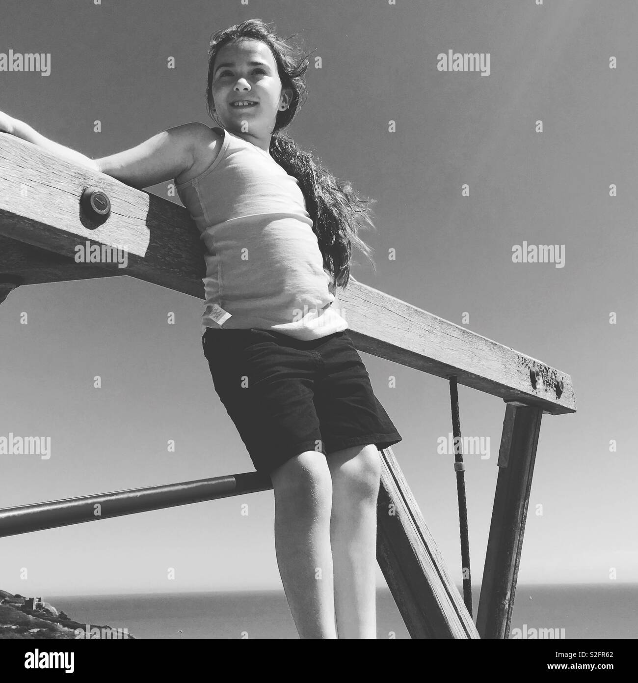 Mädchen auf Klettergerüst in Schwarz und Weiß Stockfoto