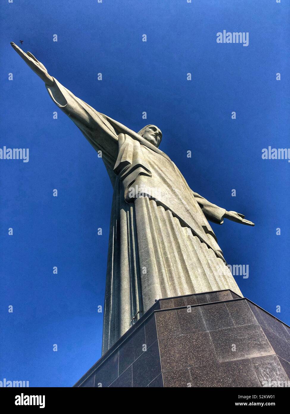 Seitliche Sicht auf das imposante Wahrzeichen dem Erlöser Christus Statue in Rio de Janeiro, Brasilien. - Smartphone-aufgenommenes Stockfoto