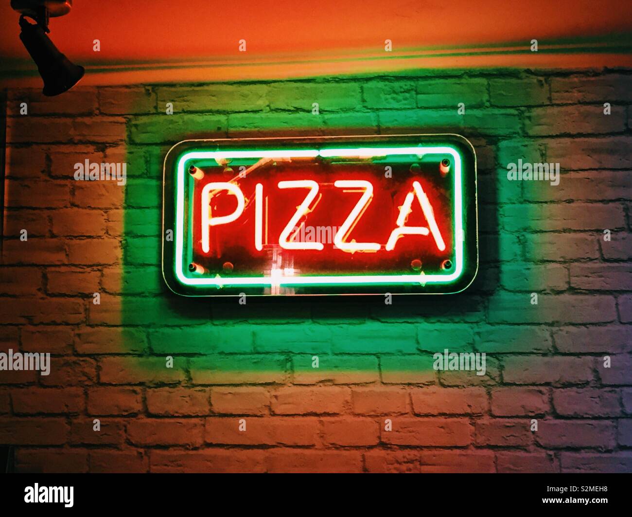 Neon Pizza Anmelden Restaurant. - Smartphone-aufgenommenes Stockfoto