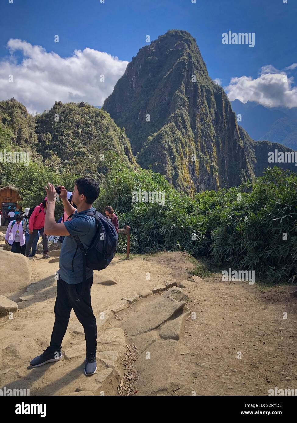 Touristische nimmt ein Handy Handy Foto Foto auf Machu Picchu Machu Picchu mit dem Gipfel des Huayna Picchu oder Wayna Picchu im Hintergrund. Peru Peru. Stockfoto