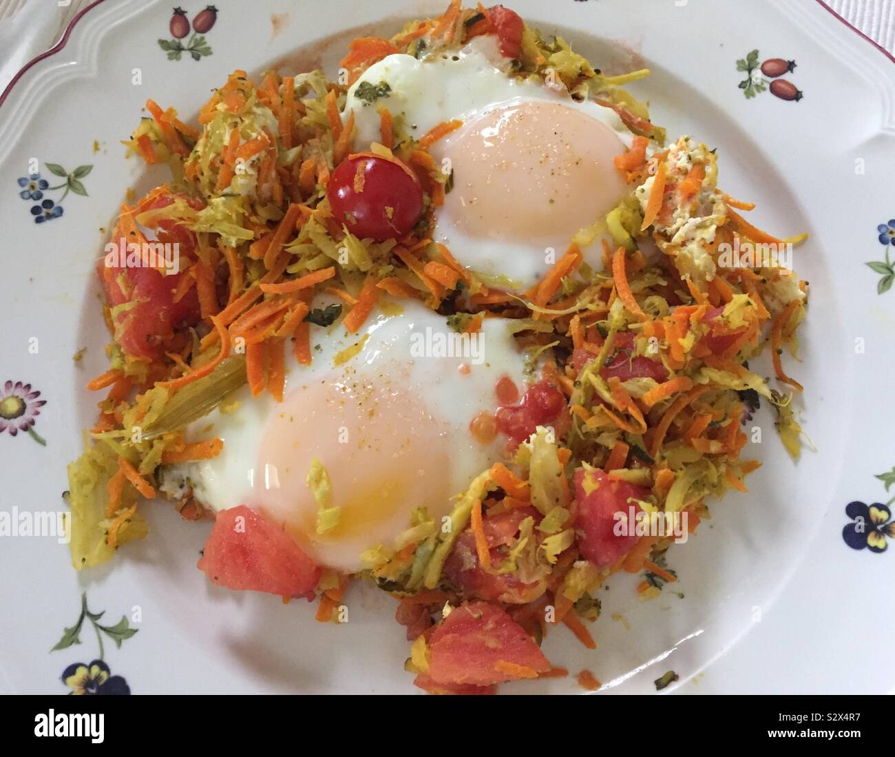 Pochierte Eier über zerkleinertes Gemüse Stockfoto