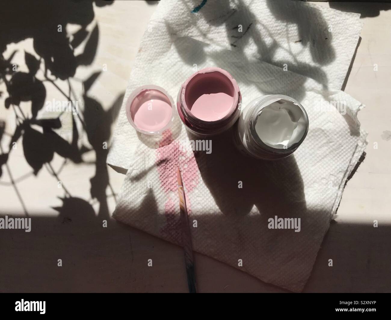 Schönen Sonnenlicht und Schatten Akzent weiss und rosa Gläser Farbe auf die Tabelle, in der ein Künstler. Stockfoto