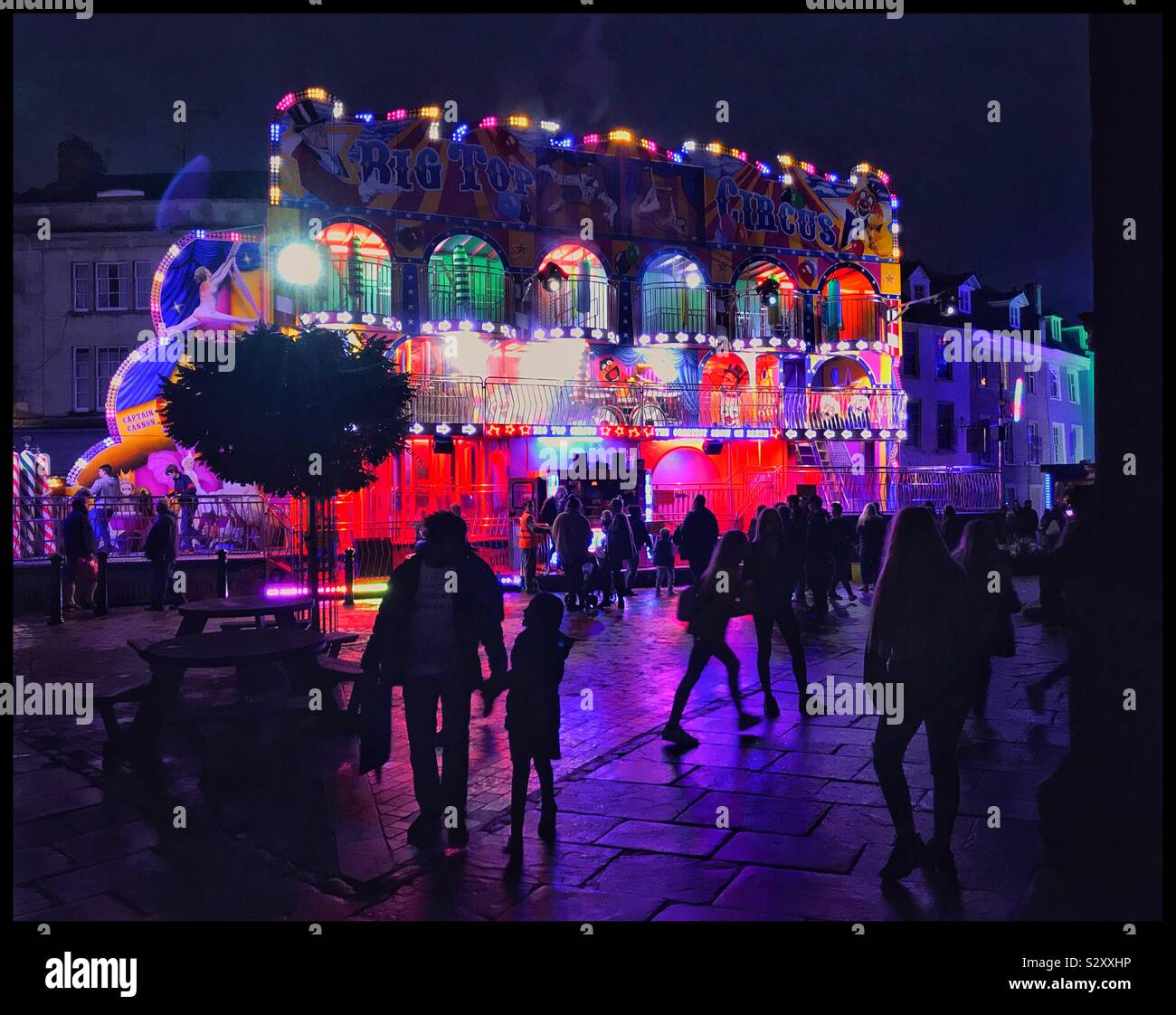 Alle die Spaß an einem Abend Jahrmarkt. Irgendwo in England. Viele Farben. Menschen in Silhouette. Foto © COLIN HOSKINS. Stockfoto