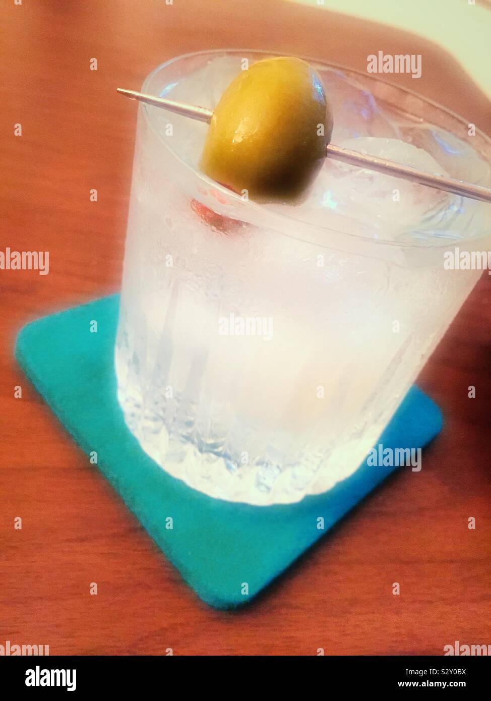 Stilisierte Nahaufnahme eines Martini auf den Felsen in einem Waterford Crystal Tumbler auf ein aqua Coaster Stockfoto