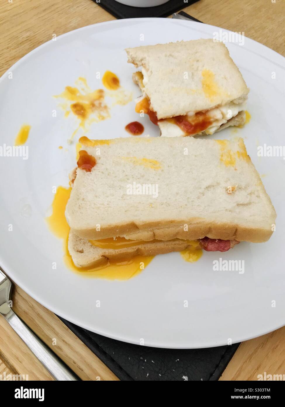 Weißes Brot, Speck und runny ei Sandwich Stockfoto