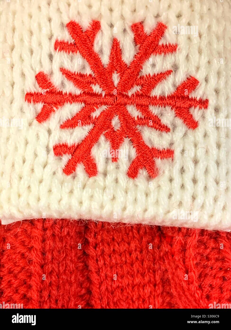 Winter Holiday red Schneeflocke auf einem fein Gehäkelte weißen und roten Hintergrund - Smartphone-aufgenommenes Stockfoto