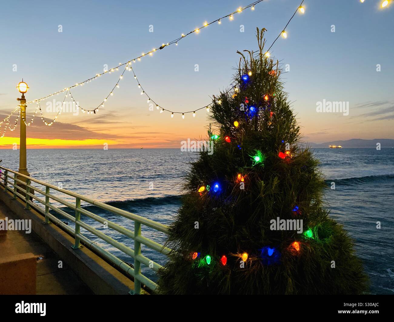 Ein Weihnachtsbaum und Urlaub Licht auf die Manhattan Beach Pier. Manhattan Beach, Kalifornien, USA. Stockfoto