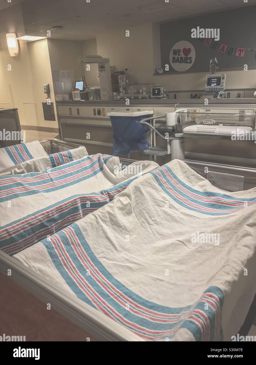 Decken und Auto-kindersitze bereit für neugeborene Babys hinter dem Fenster im Krankenhaus Kindergarten Stockfoto