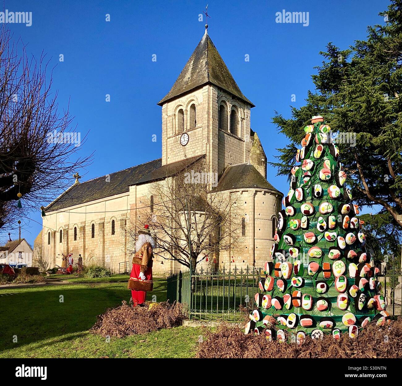 Alternative Weihnachtsbaum vor der mittelalterlichen Kirche, Bossay-sur-Claise, Indre-et-Loire, Frankreich. - Smartphone-aufgenommenes Stockfoto