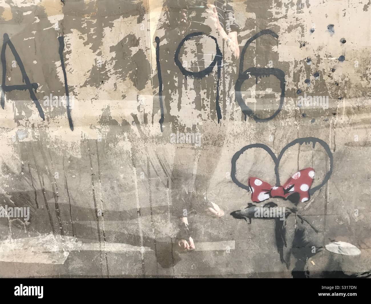 Banksy Mickey Mouse street art in Paris, Frankreich gefunden, Latin erhalten hinter Plexiglas. - Smartphone-aufgenommenes Stockfoto