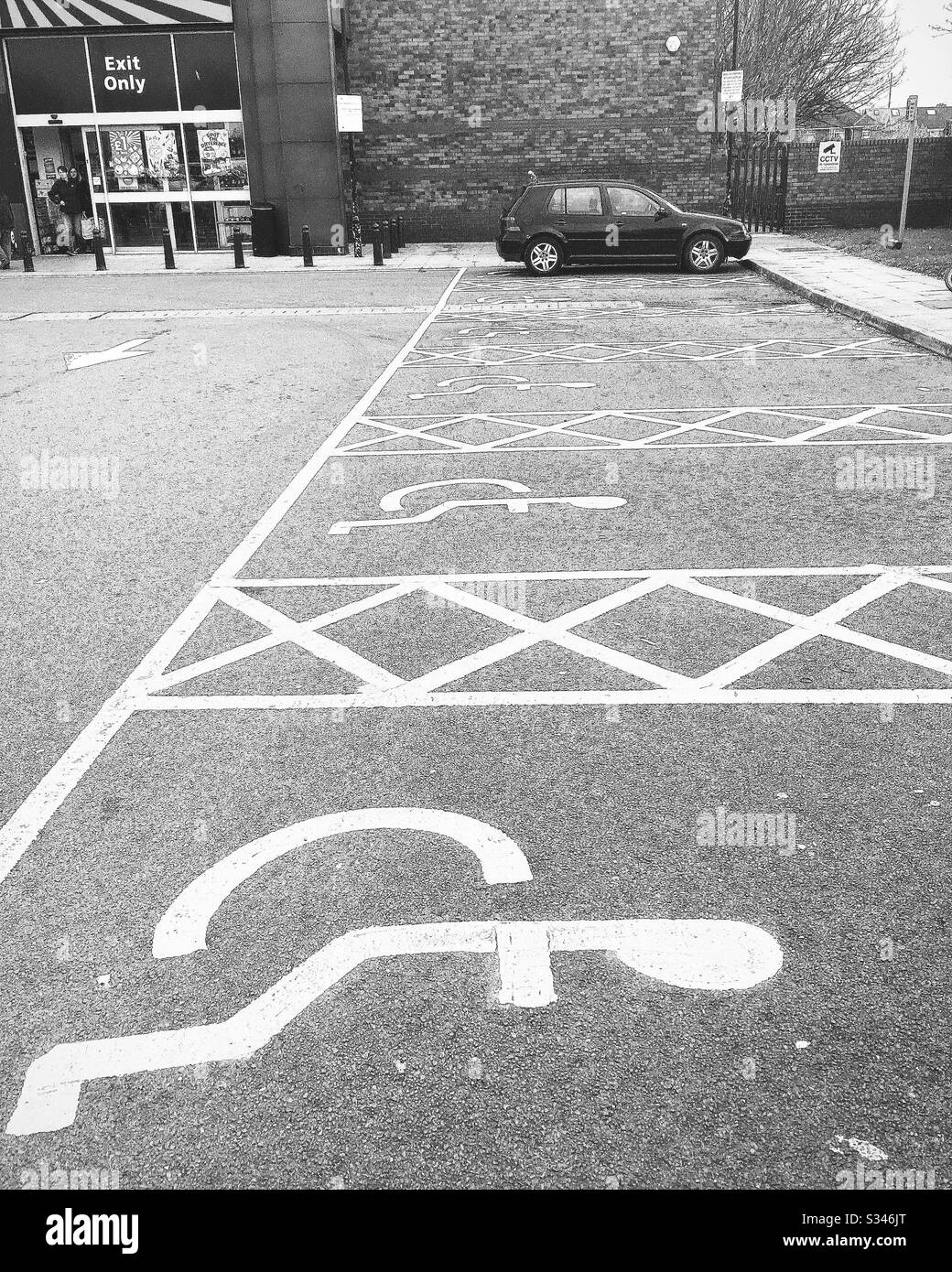 Behinderten-Parkplätze auf einem Parkplatz, außerhalb von Geschäften in England, Großbritannien Stockfoto