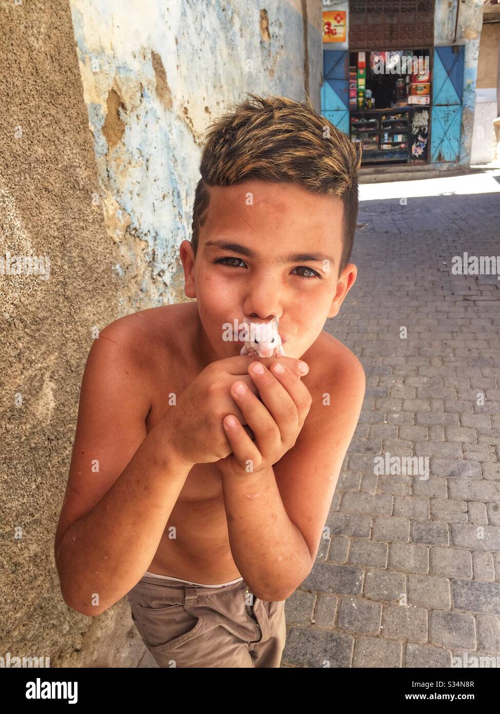 Marokkanisches Straßenkind mit Maus Stockfoto