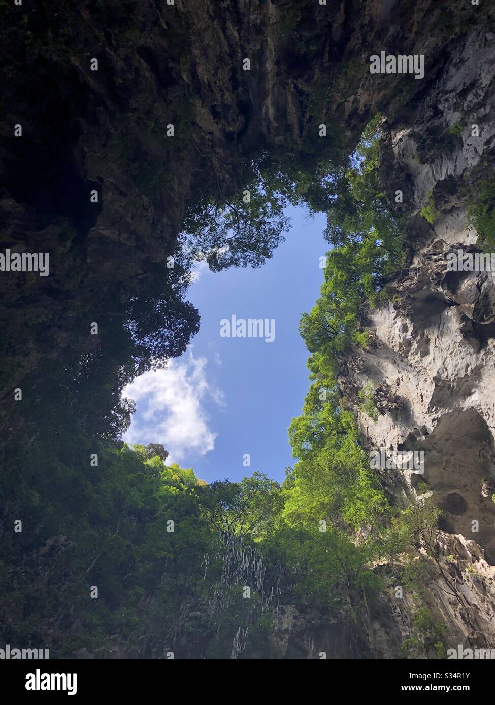 Blauer Himmel durch ein Loch in den Batu Caves in Kuala Lumpur, Malaysia. Stockfoto
