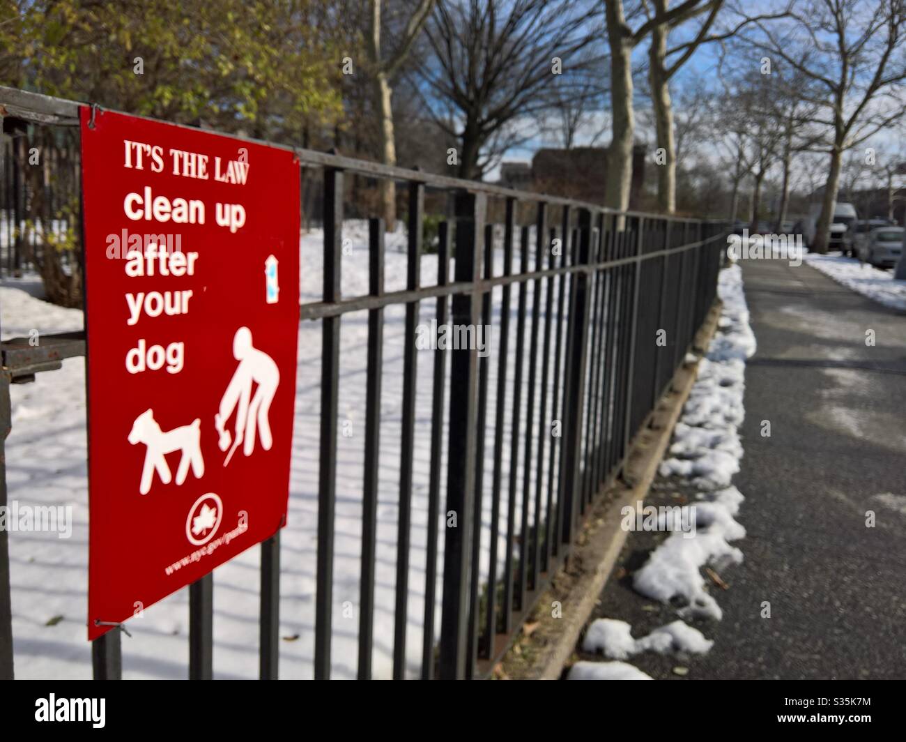 Reinigen Sie nach Ihrem Hundeschild am Zaun des Butterfly Park auf der 7th AVE und 18th Street in South Park Slope, Brooklyn Stockfoto