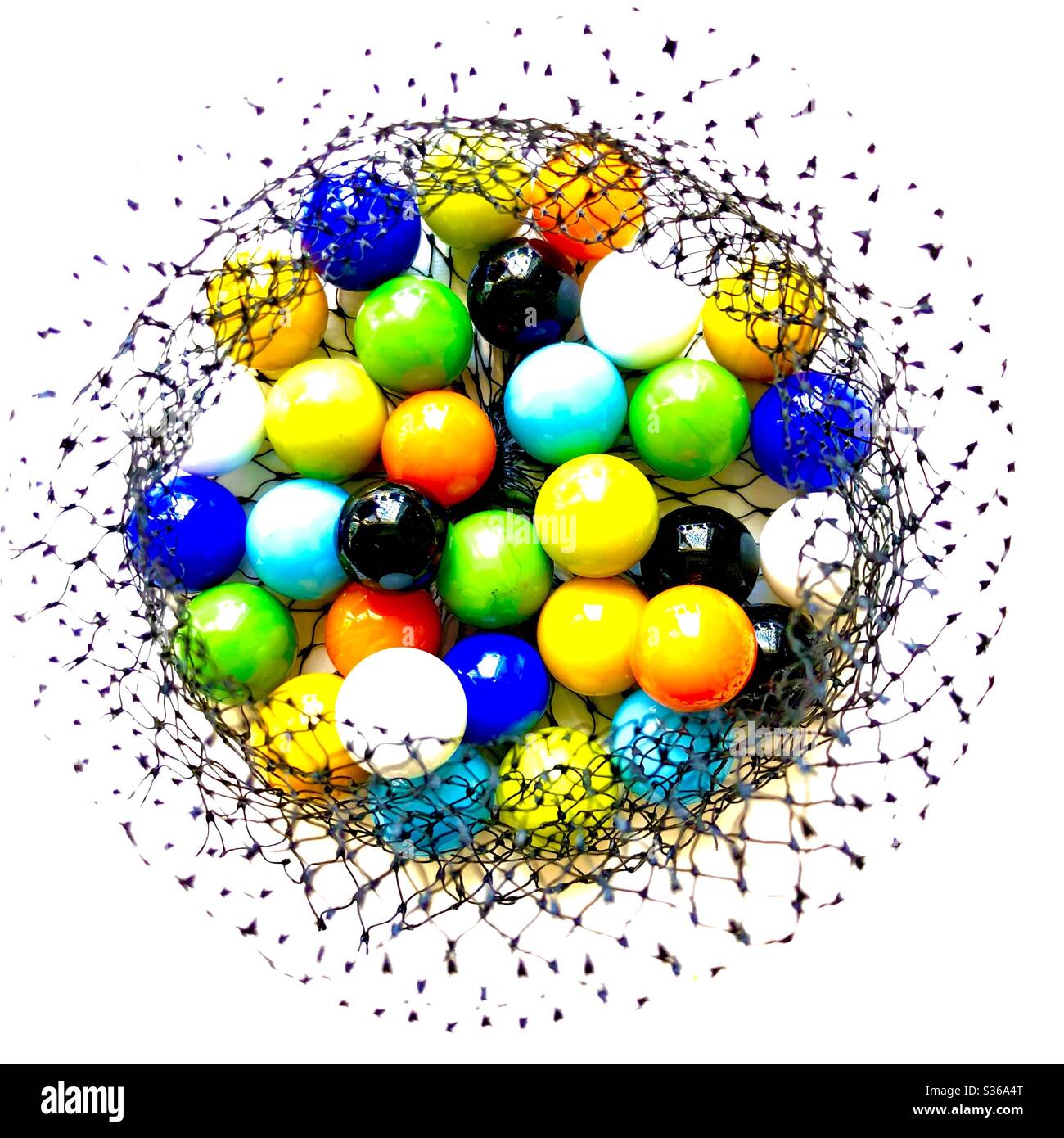 Bunte Glasmurmeln in einem schwarzen Netz, weißer Hintergrund - Smartphone-aufgenommenes Stockfoto