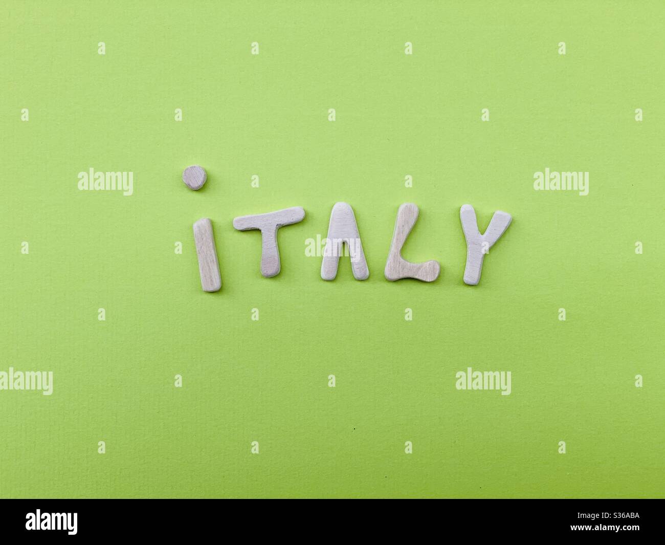 Italien, Souvenir mit handgefertigten Holzbuchstaben über grüner Farbe - Smartphone-aufgenommenes Stockfoto