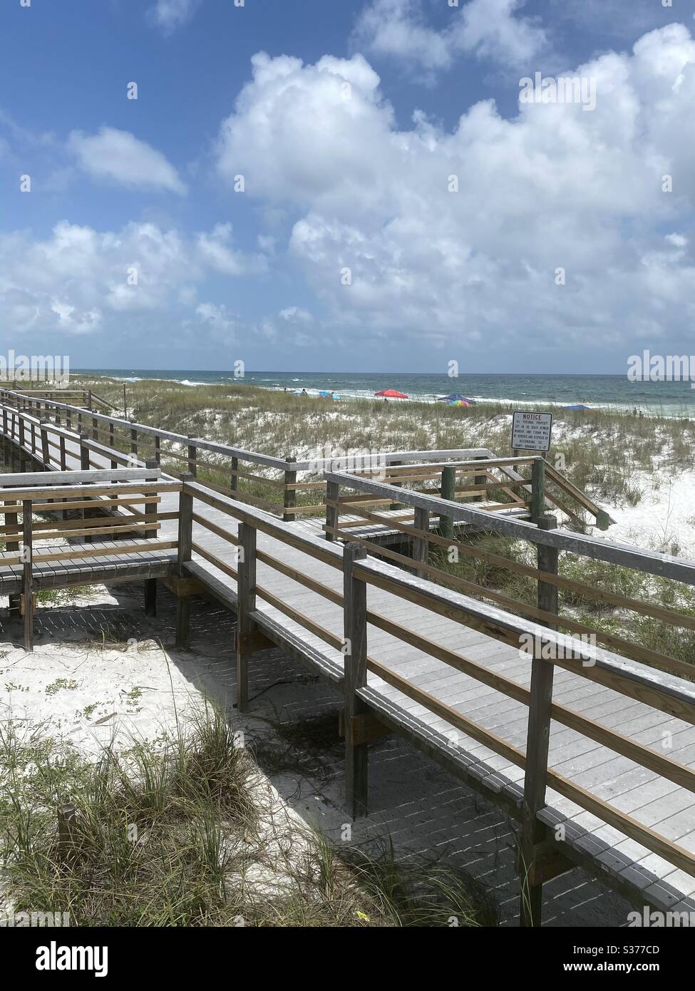 Blick von oben auf Holzsteg, der zum weißen Sandstrand an der Emerald Coast Florida führt Stockfoto