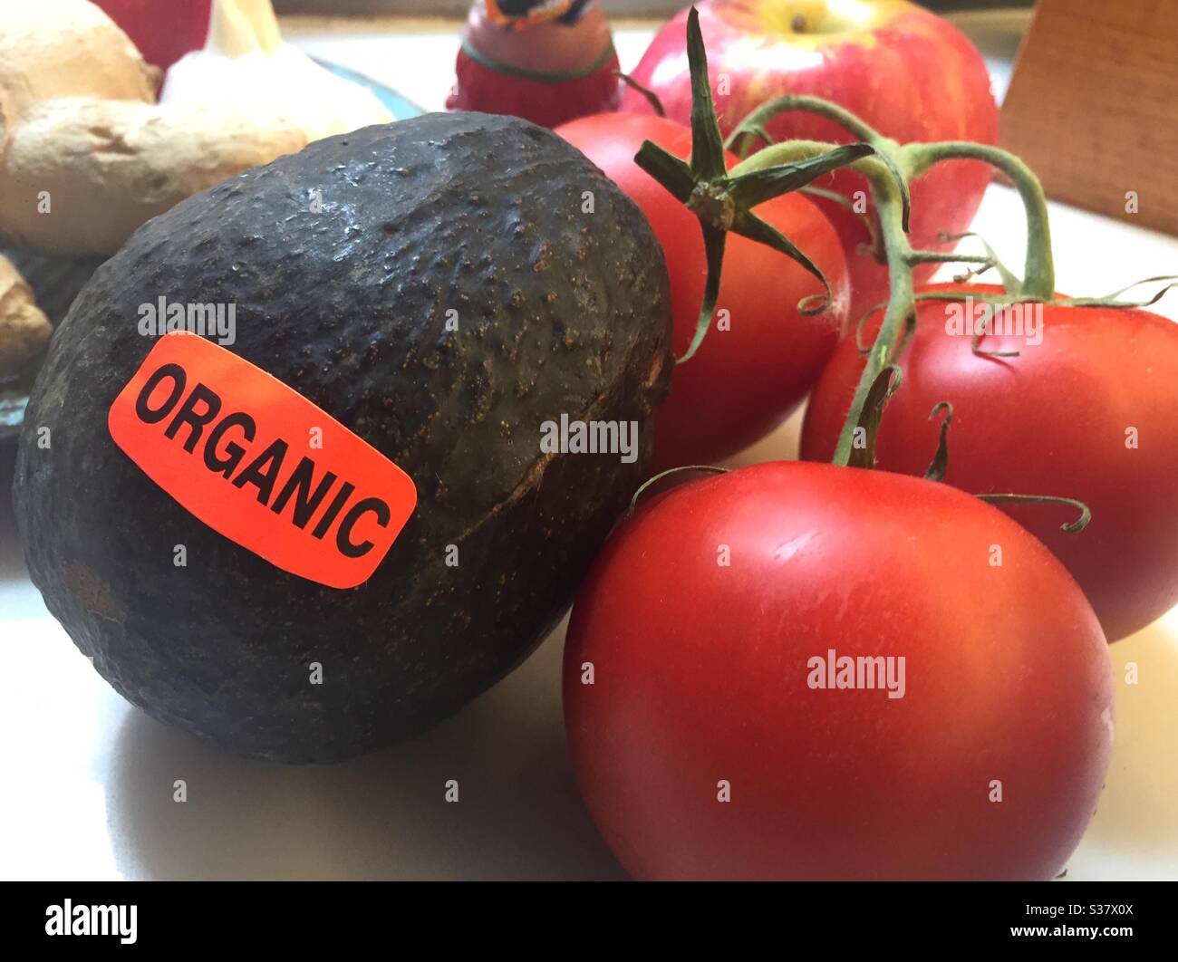 Nahaufnahme einer Bio-Avocado und Rebe gereiften Tomaten auf einer Küchentheke, USA Stockfoto