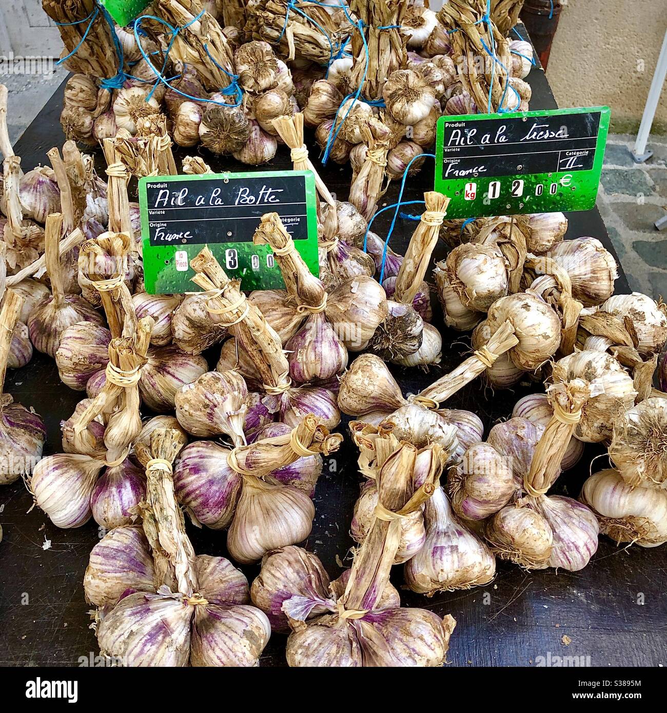 Französischer Marktstand mit Knoblauch zum Verkauf. - Smartphone-aufgenommenes Stockfoto