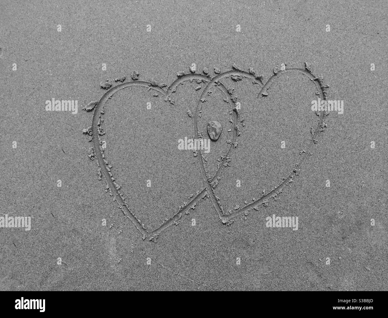 Herzen im Sand. Fels in der Kreuzung symbolisiert ein flinty Herz. Konzepte: Herz zählt, Linie im Sand, ikonisch, Symbole, verbunden, Liebe. Beach, Halifax, Kanada Stockfoto