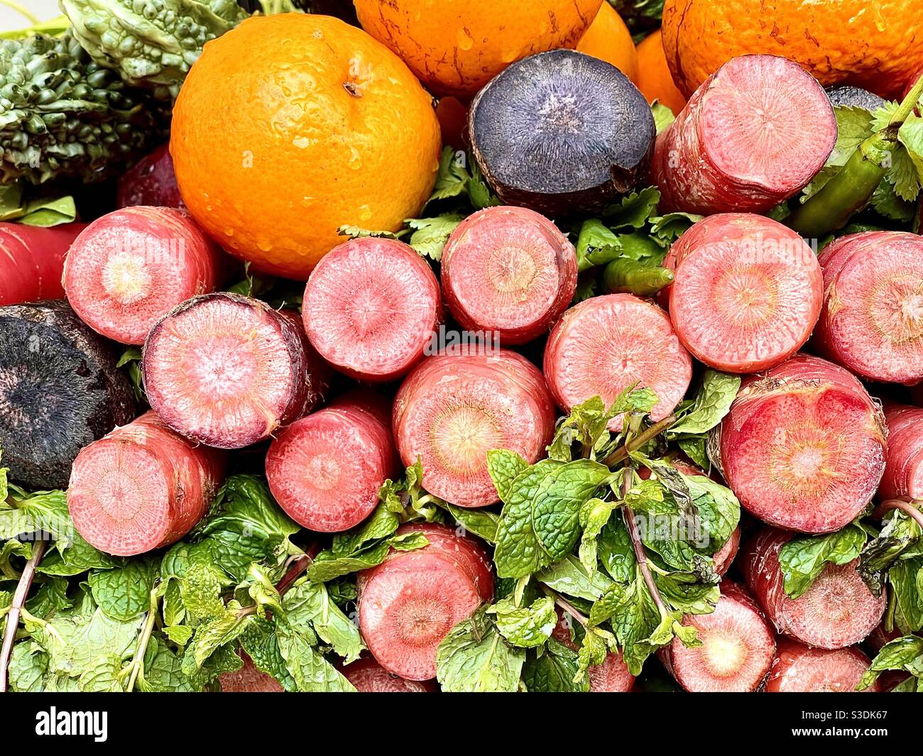 Orangen, Karotten und Minzblätter - werden für die Herstellung von Mischsaft verwendet - ein gesunder Saft Stockfoto
