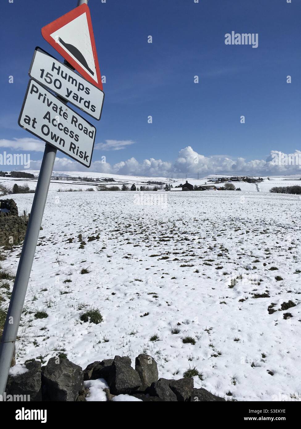 Straßenschild auf den Hügeln im Schnee Stockfoto