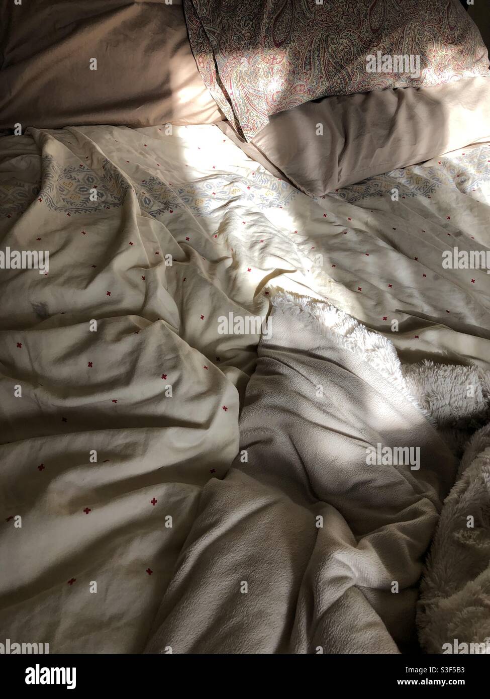 Bett und Sonnenlicht. - Smartphone-aufgenommenes Stockfoto