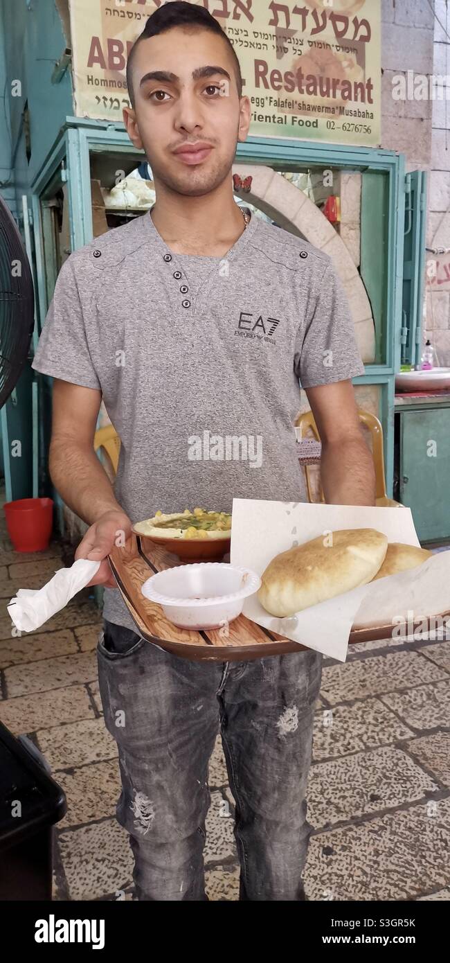 Frischer palästinensischer Hummus wird im Abu Kamel Hummus Restaurant im christlichen Viertel in der Altstadt von Jerusalem serviert. - Smartphone-aufgenommenes Stockfoto