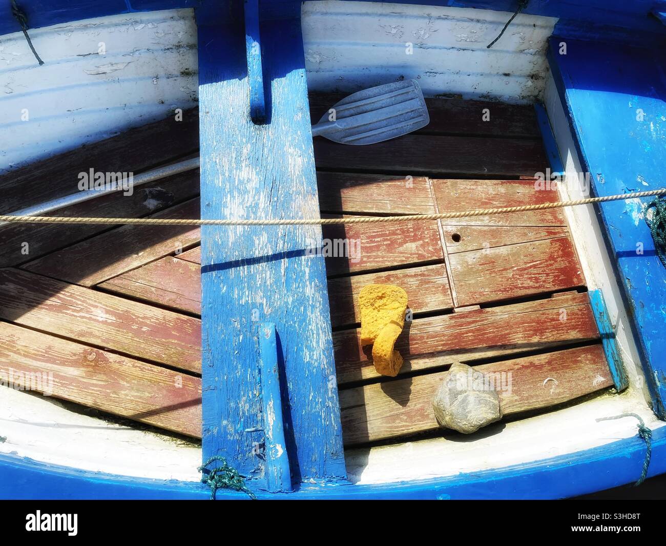 Kleines Ruderboot, das im August in einem kornischen Hafen vor Anker liegt. Stockfoto