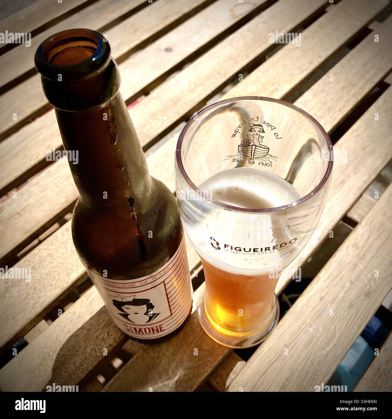Flasche lokal gebrautes „Simone“-Bier in halbvollem Glas - Tours, Indre-et-Loire (37), Frankreich. Stockfoto