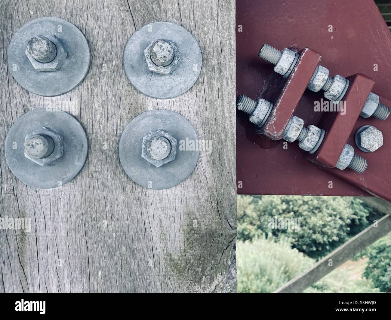 Graue Metallschrauben und Muttern halten einen roten Metallrahmen und einen grauen Holzbalken Stockfoto